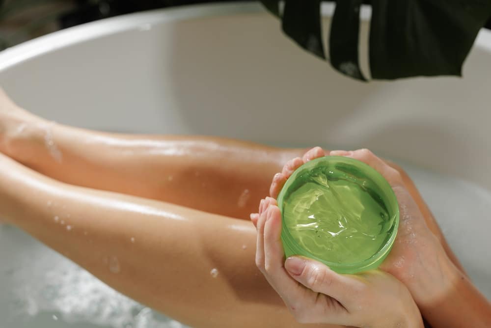 AWomanAppliesAloeVeraGelWhileRelaxingInA - SomethingBeautiful!!