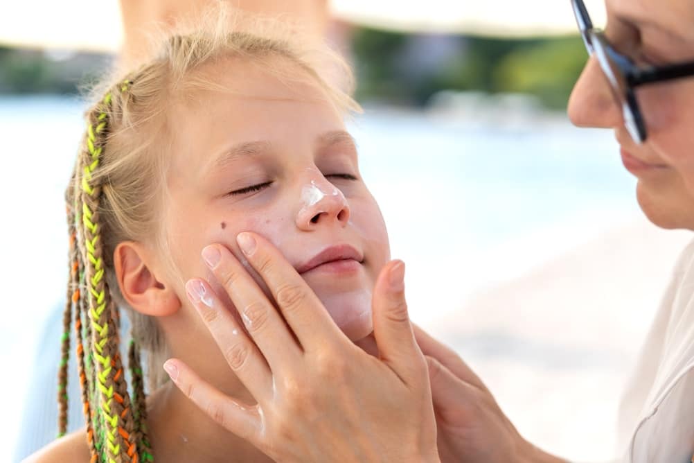 MotherApplyingSunscreenChildFaceNoseSunnyHotBeachDay - SomethingBeautiful!!