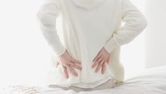AWomanCaringAboutHerPainfulLowerBack - SomethingBeautiful!!