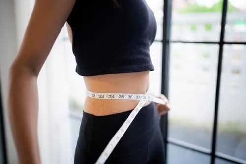 AsianHealthyWomanDietingWeightLossSlimWomanMeasuringWaist - SomethingBeautiful!!
